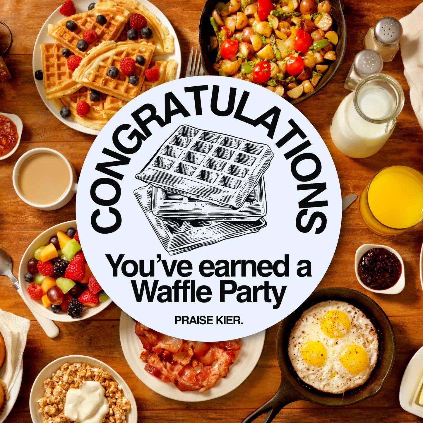 Congratulations, you’ve earned a Waffle Party. Praise Kier.” sticker placed over a vibrant breakfast table full of waffles, fruit, eggs, and juice.
